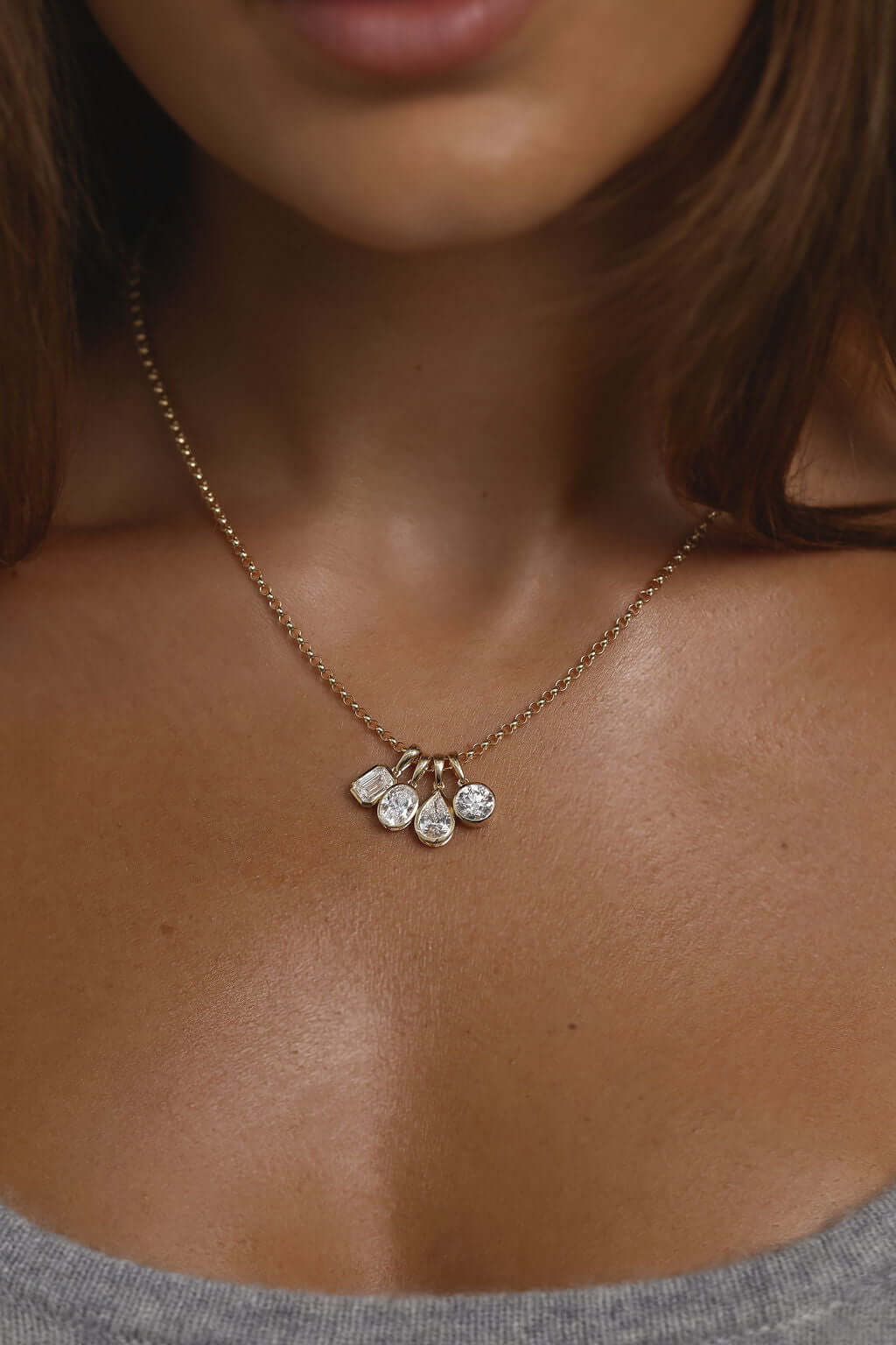 1ct Pear Lab Diamond Bezel Pendant in 9ct yellow gold worn on a person's neck.