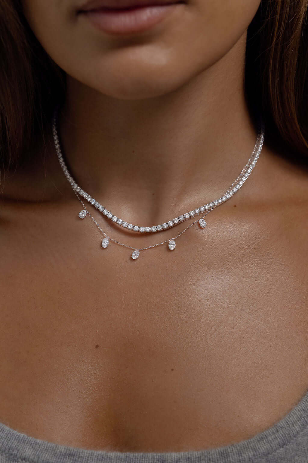 Hanging Oval Diamond Station Necklace 1.6ct Lab Diamond displayed on a woman's neck with sparkling diamonds.