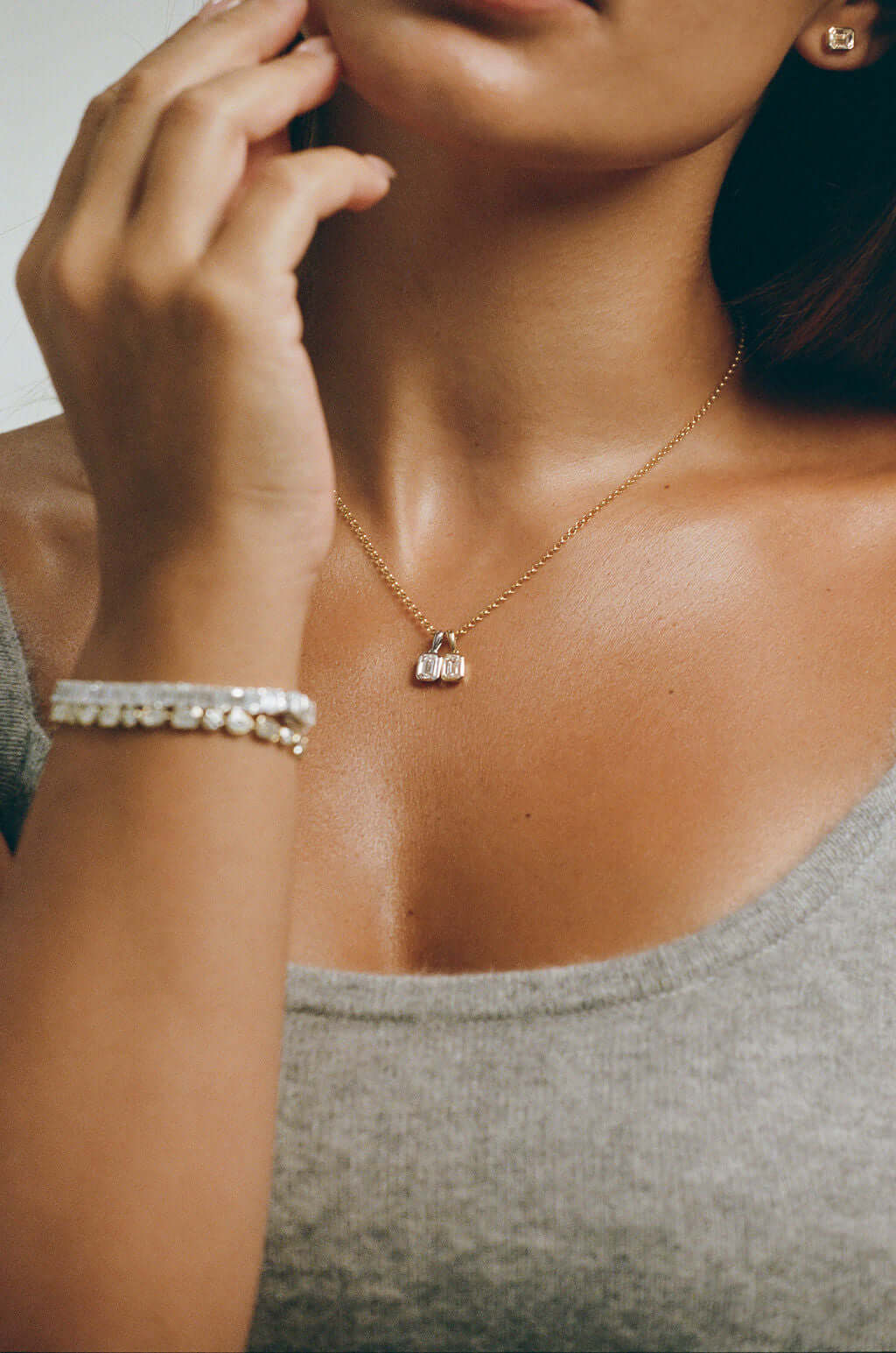 Model wearing a 1ct Emerald Lab Diamond Bezel Pendant in 9ct yellow gold on a delicate chain.