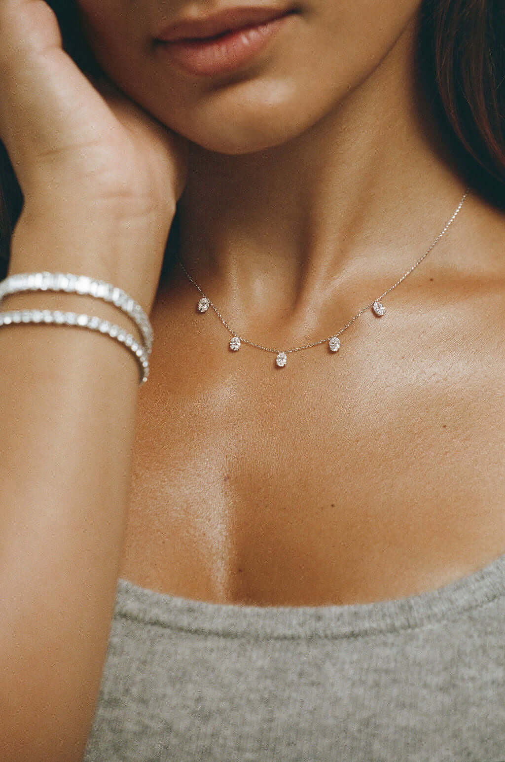Hanging Oval Diamond Station Necklace 1.6ct Lab Diamond worn by a model with bracelets.