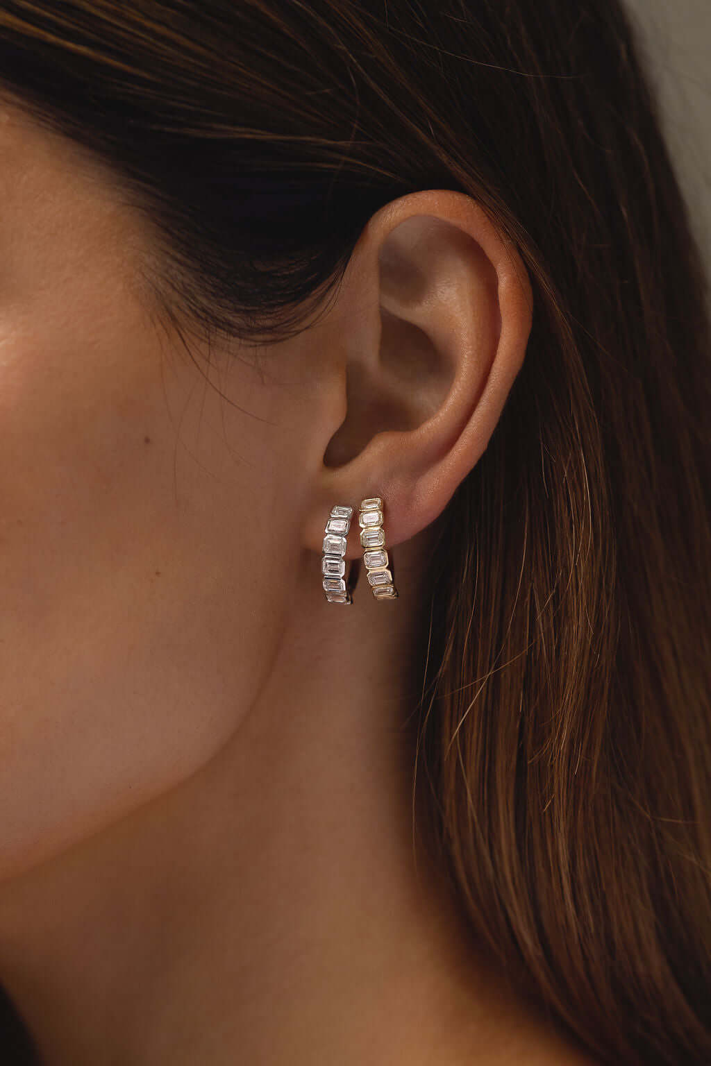 Emerald Bezel Hoop Earrings Lab Diamond worn by a model showcasing their elegance in this close-up image.