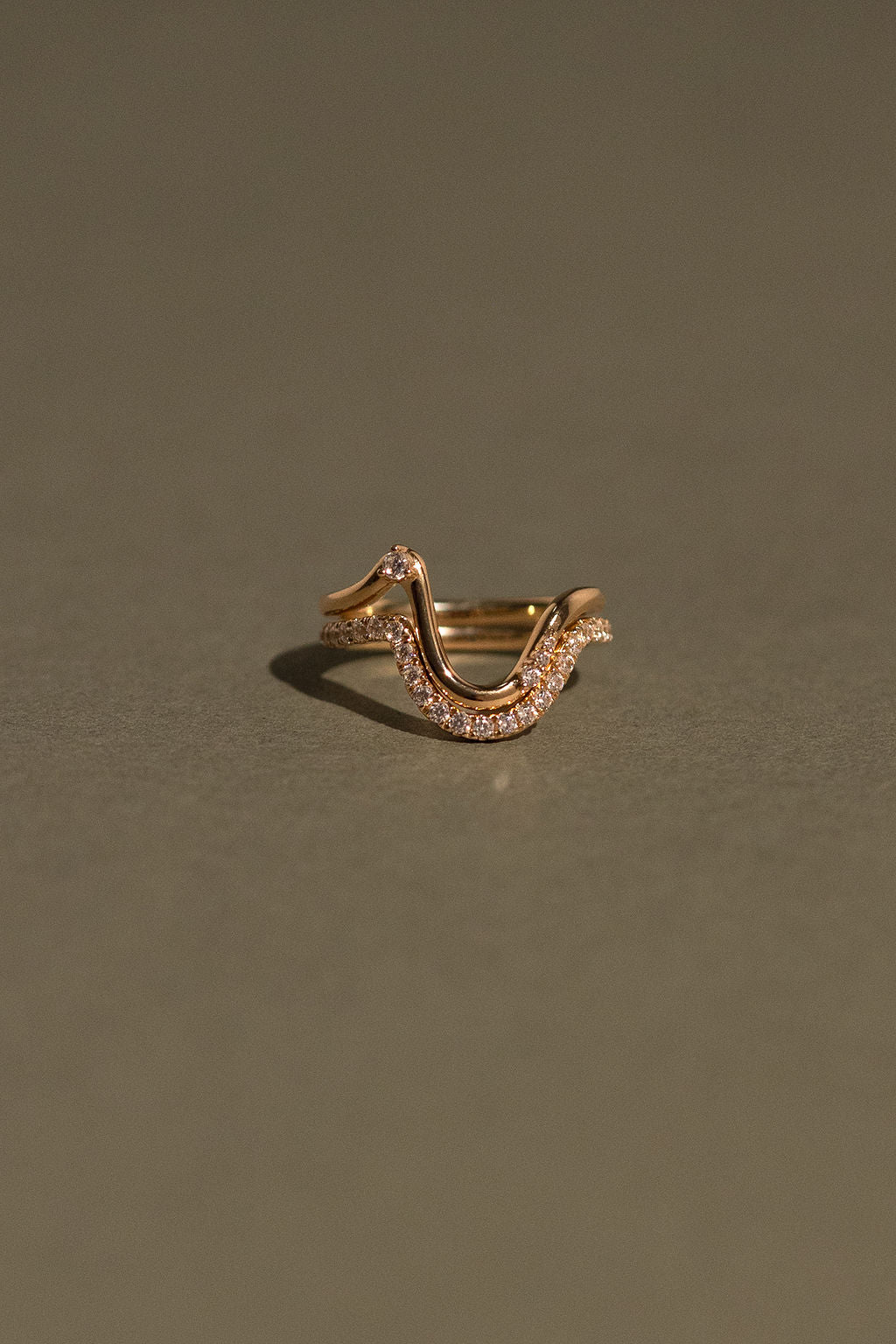 Gold ring with small diamonds on a green background