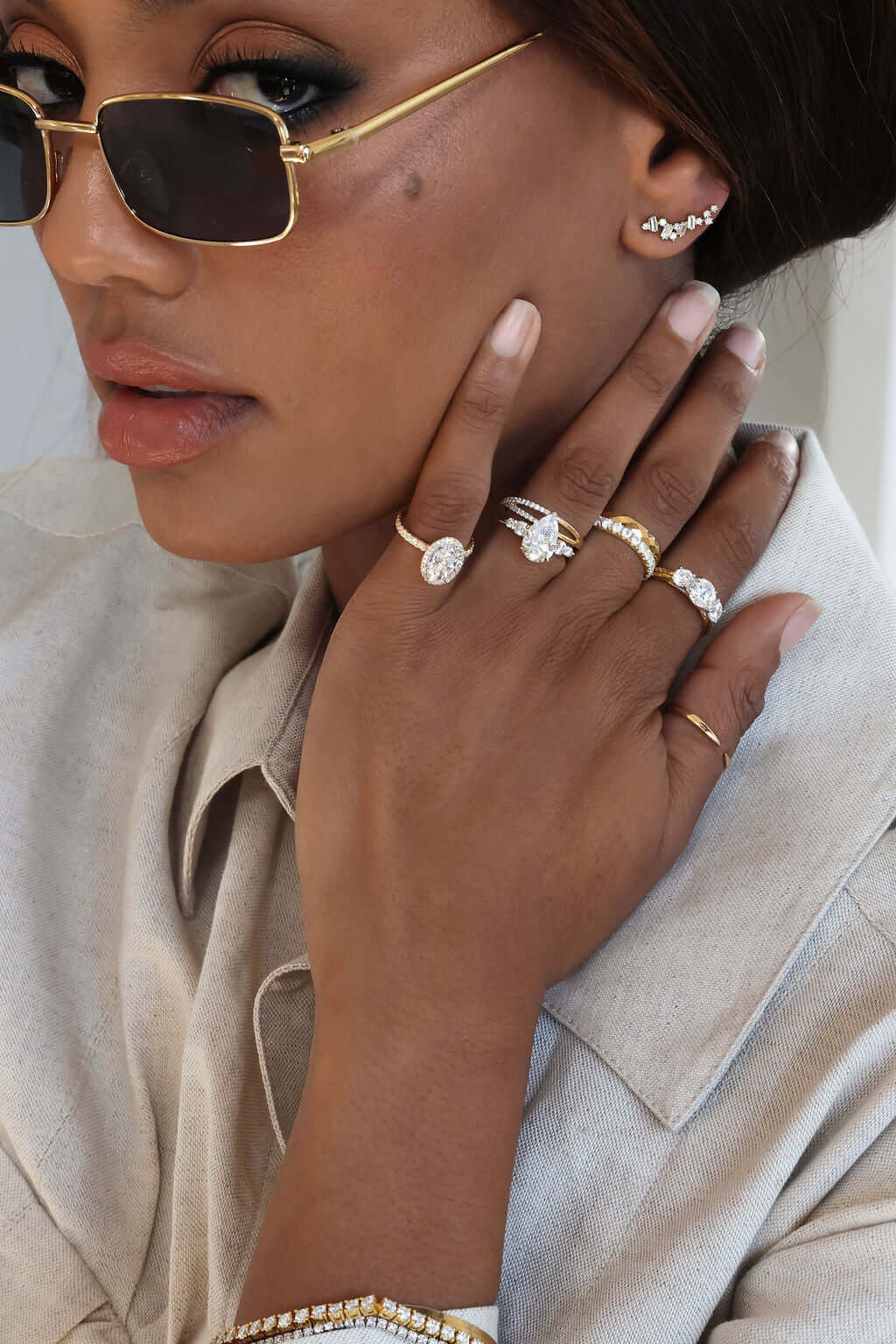 woman wearing multiple rings and earrings