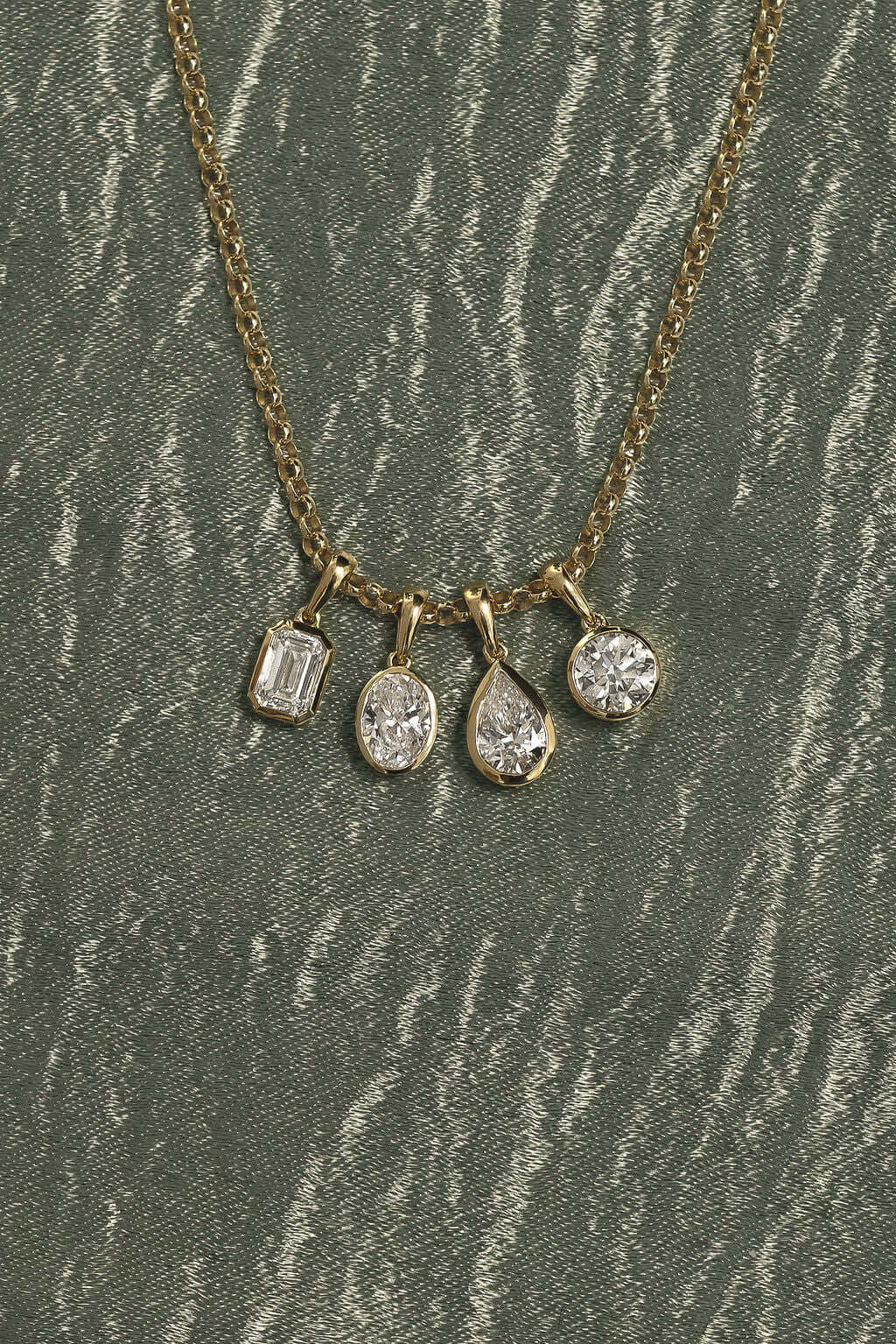 1ct Pear Lab Diamond Bezel Pendant featuring multiple diamond shapes on a gold chain