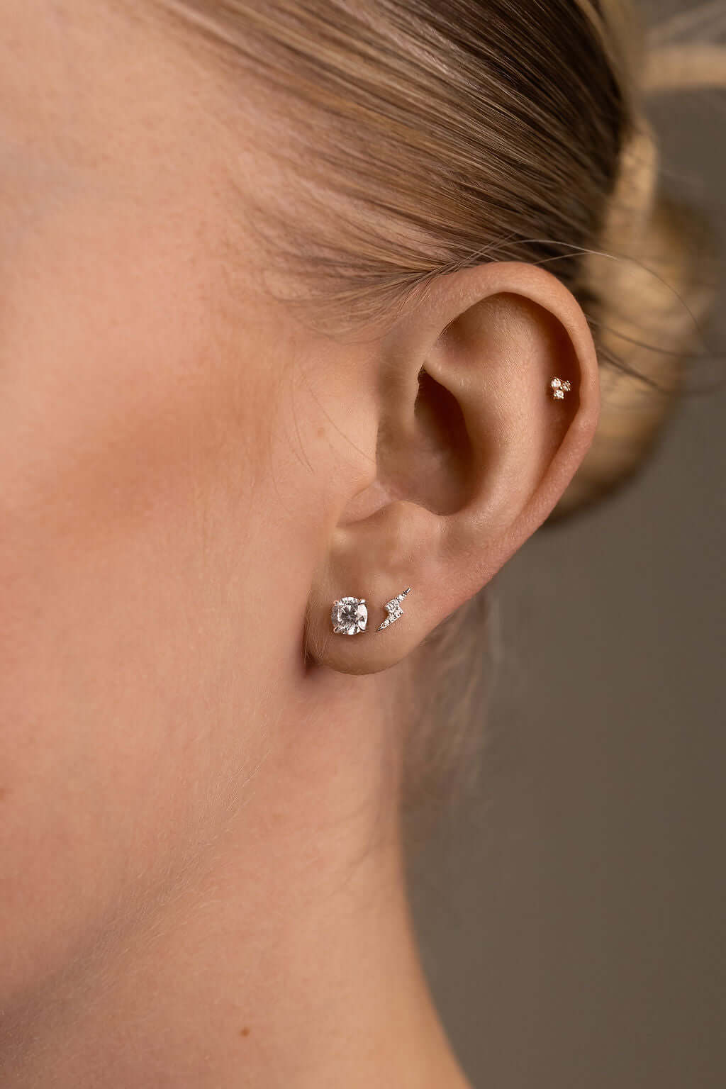 Round Brilliant Stud Earrings Lab Diamond showcased on a model's ear, featuring F/VS diamonds in white gold setting.
