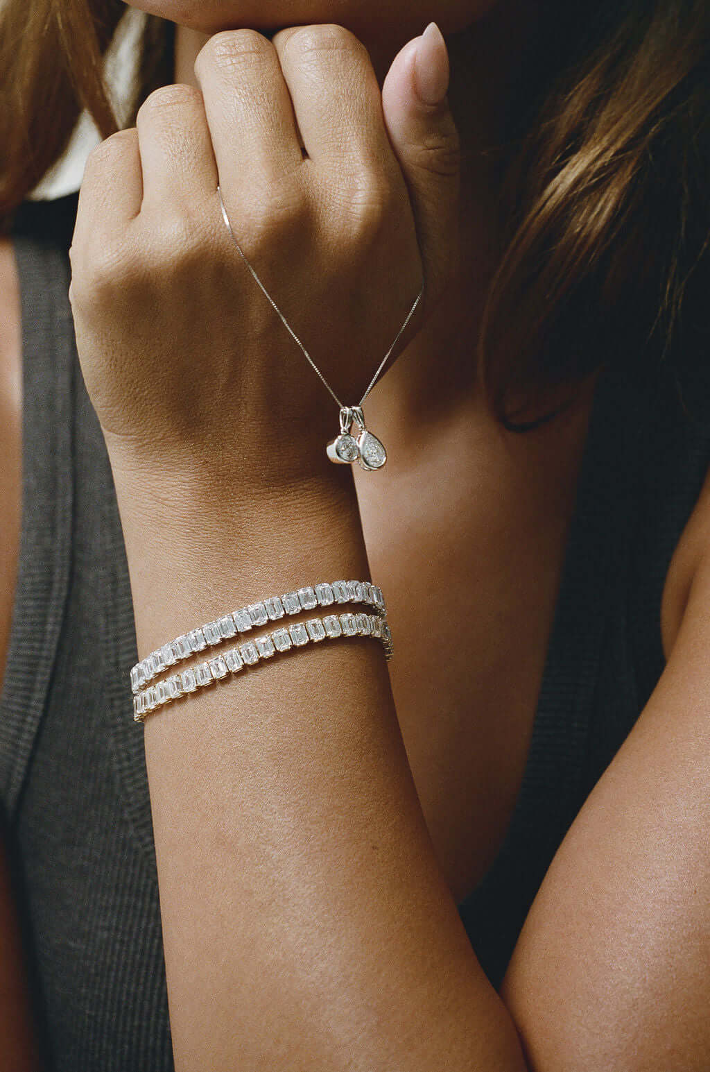 Emerald Bezel Tennis Bracelet 15ct Lab Diamond worn with a delicate necklace showcasing exquisite design and shine.