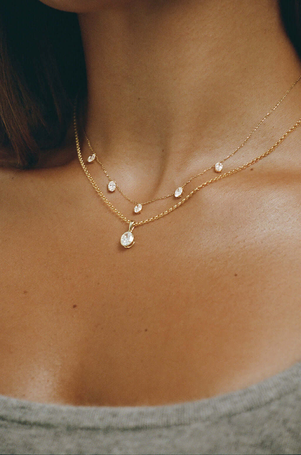 Hanging Oval Diamond Station Necklace 1.6ct Lab Diamond worn by a model, featuring gold chains with diamonds.