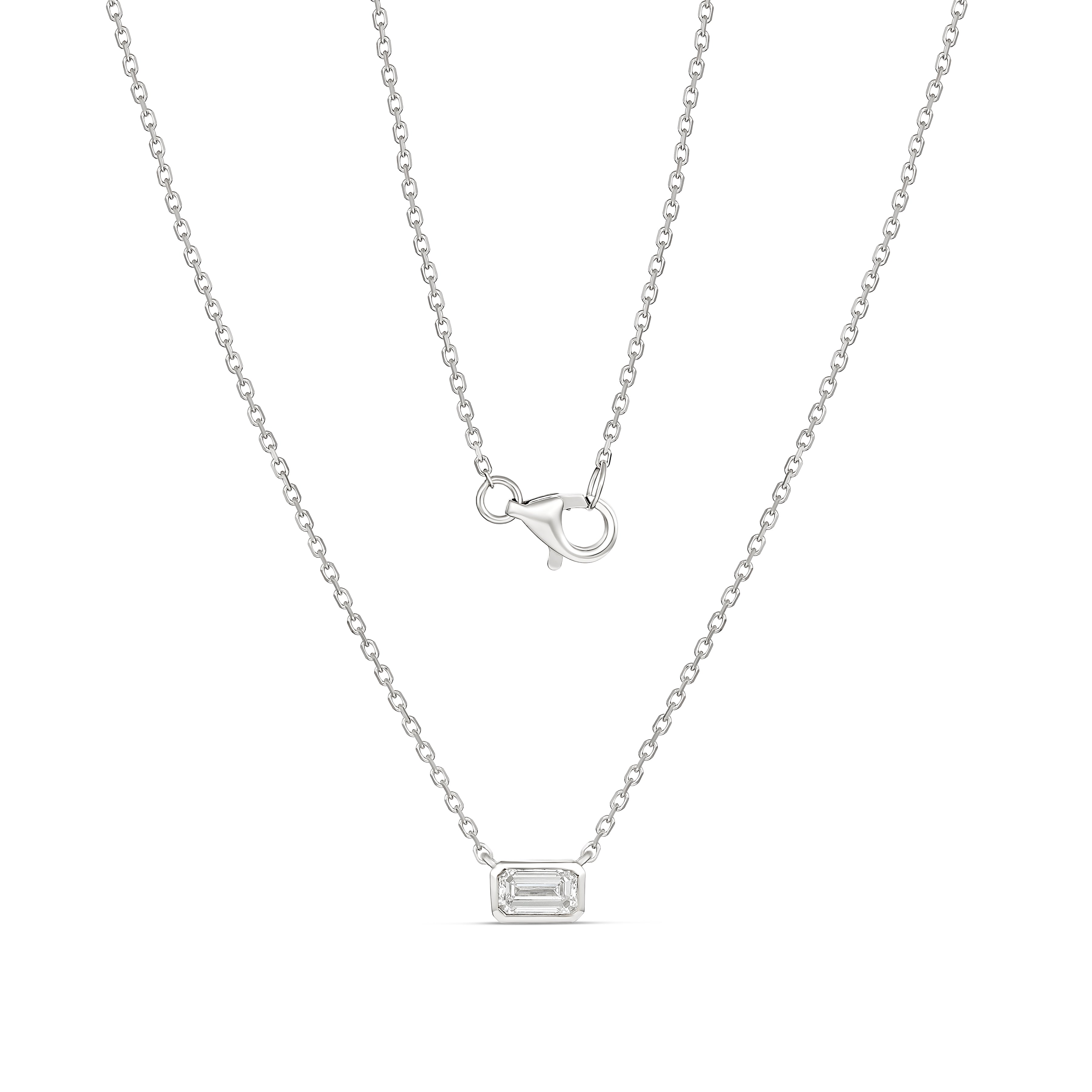 white gold necklace with a rectangular pendant on a white background