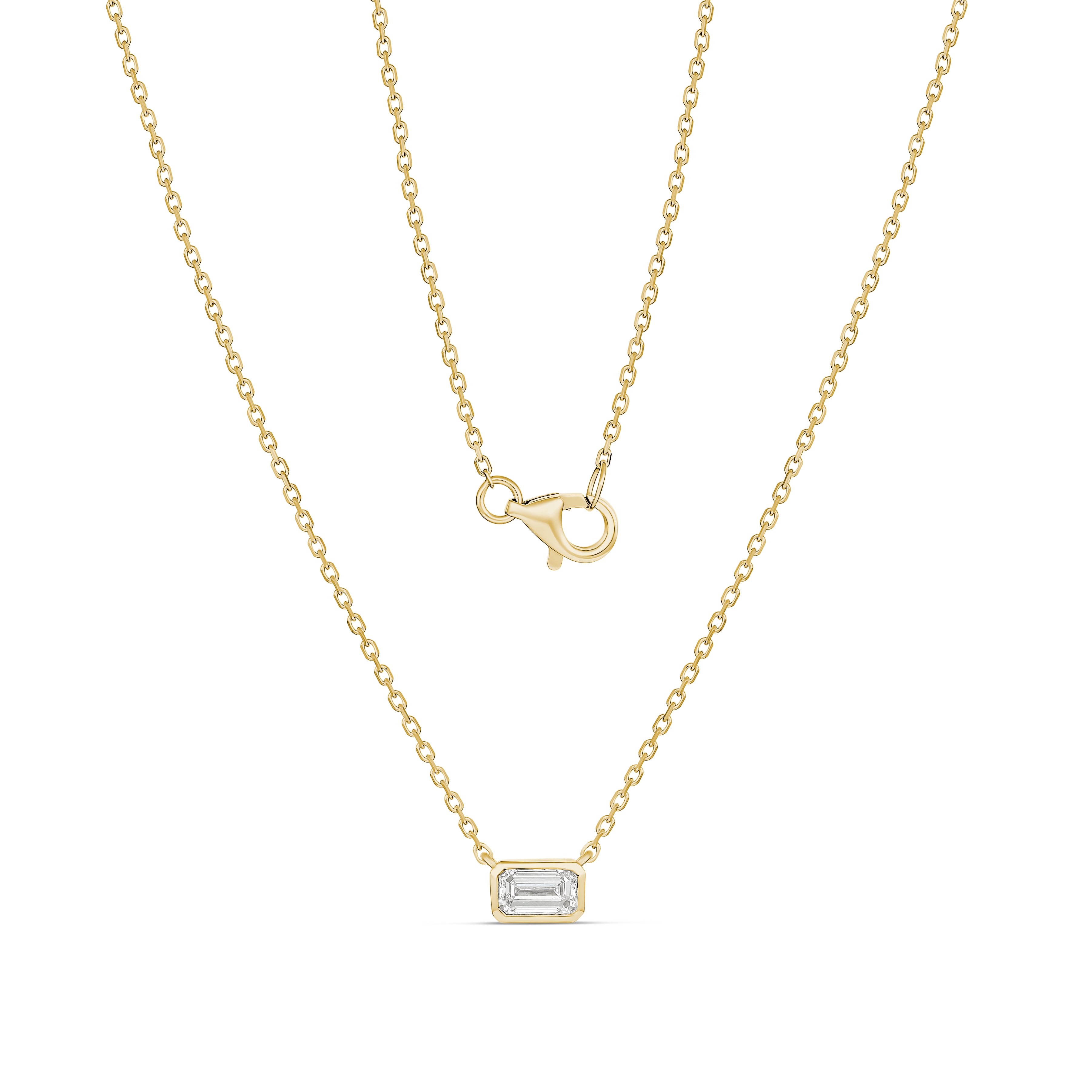 Gold necklace with a rectangular pendant on a white background