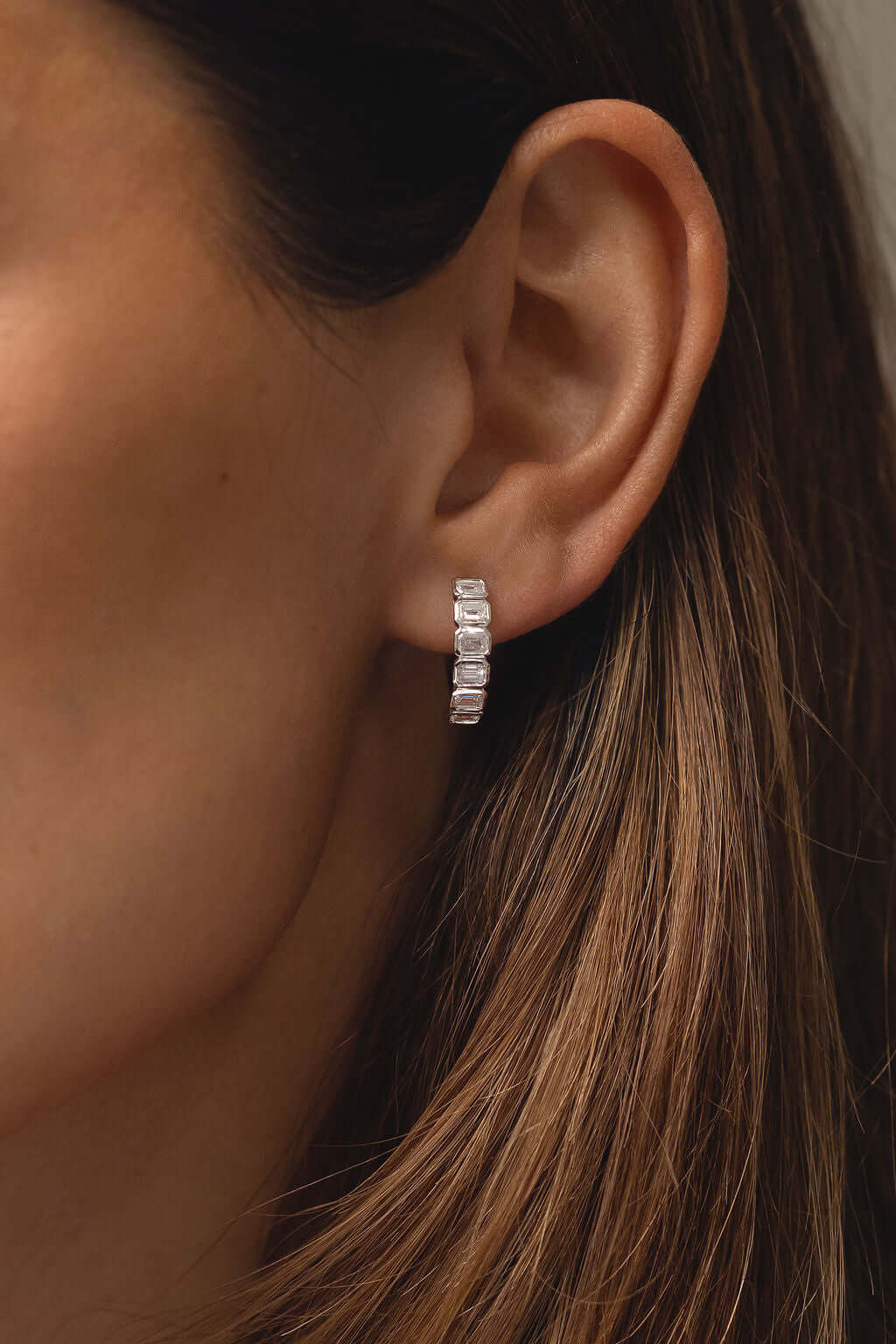 Emerald Bezel Hoop Earrings Lab Diamond worn by model, showcasing elegance and style in white gold with diamonds.