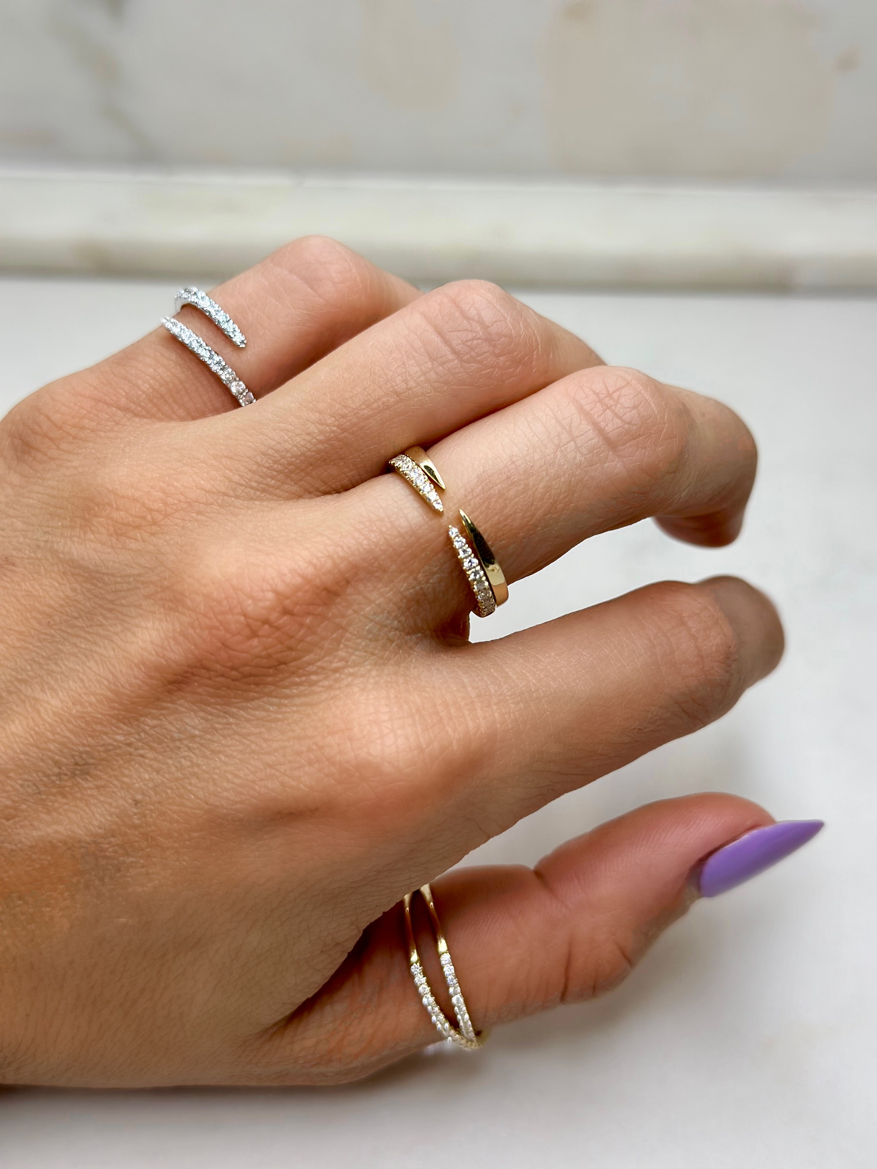 gold claw rings stacked on top of eachother